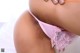 A close up of a woman wearing a pink thong.