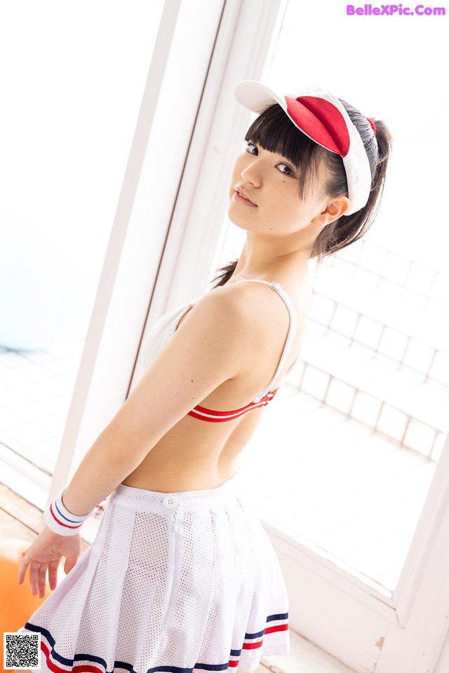 A woman in a white and red outfit posing for a picture.