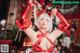 A woman in a red bikini posing in front of a Christmas tree.