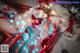 A woman in a red lingerie laying on a blanket covered in lights.