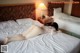 A woman laying on a bed in a hotel room.