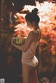 A woman holding a bowl of watermelon in her hands.