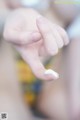 A close up of a person's hand holding a small white object.