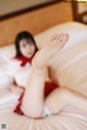 A woman laying on a bed with her feet up.