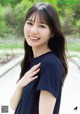 A woman in a black shirt posing for a picture.