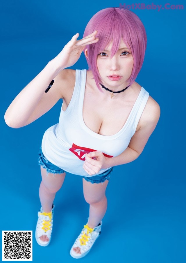 A woman with pink hair and a white tank top.