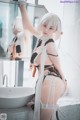 A woman in lingerie posing in front of a mirror.
