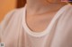 A close up of a woman's neck with water droplets on it.